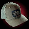 Dark green mesh trucker hat with our full logo on a black leather patch.