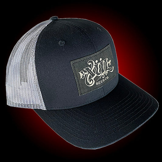 Black mesh trucker hat with our full logo on a black leather patch.
