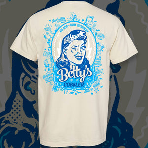 Comfort Colors tan shirt with our Betty's Cobbler can art on the back in light and dark blues.