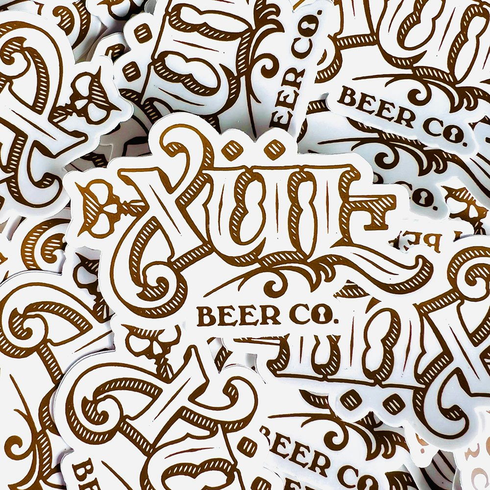 stack of classic logo stickers in white and gold